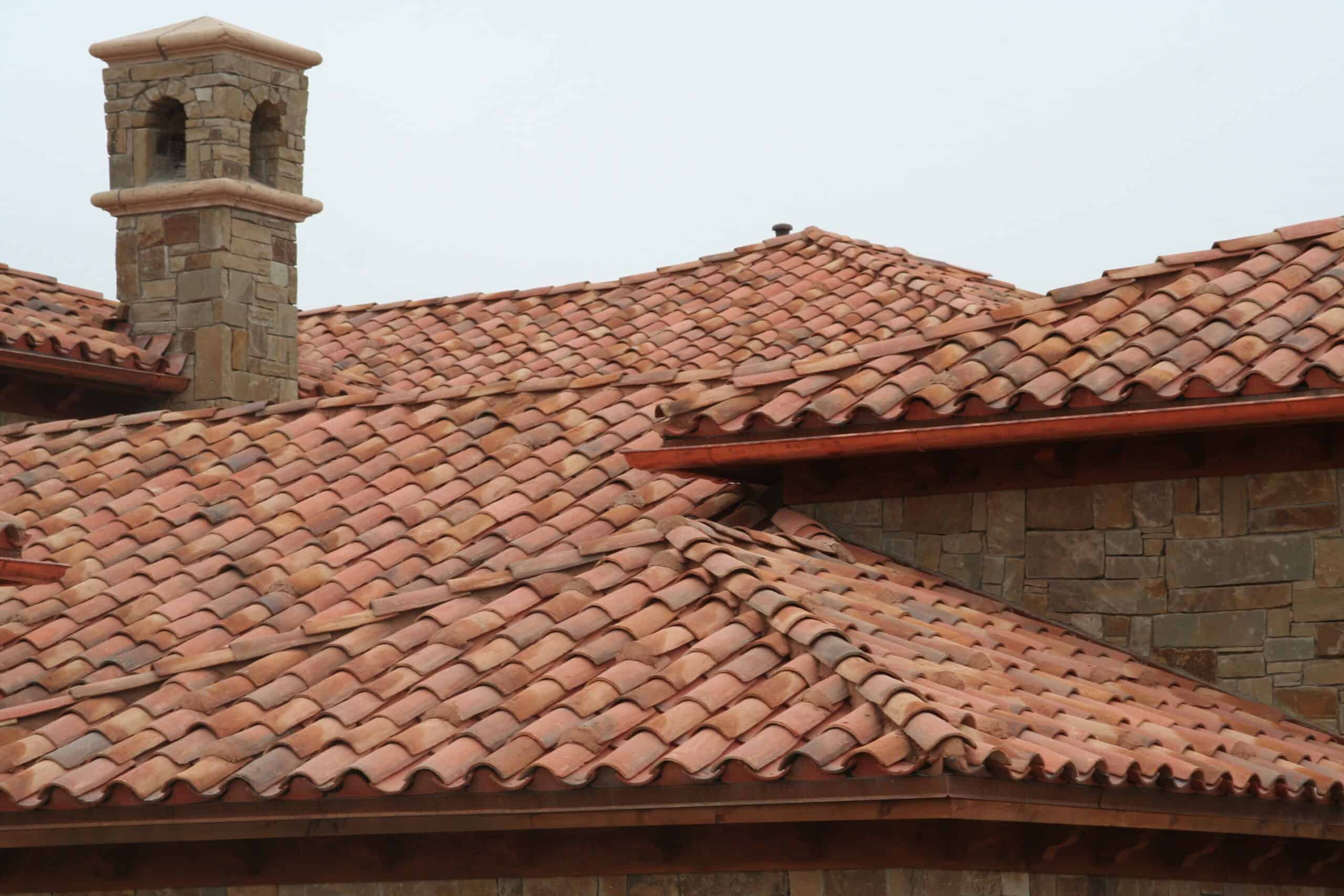 Looking up at the eaves, hips and ridge tiles on a Castilla Limestone roof.