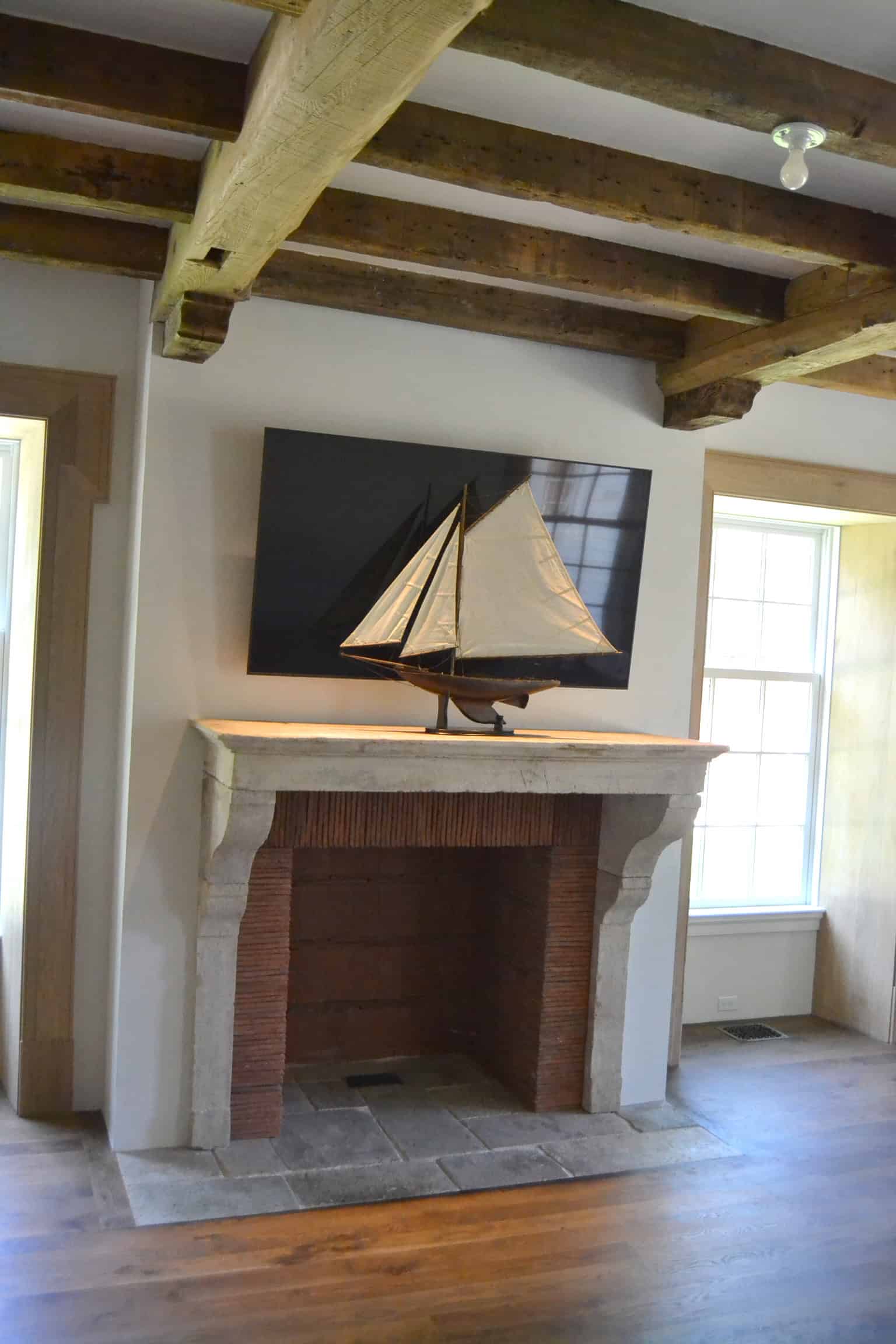 Roof tiles used as a fireplace surround and fireback. Designed by John Toates Architecture & Design LLC