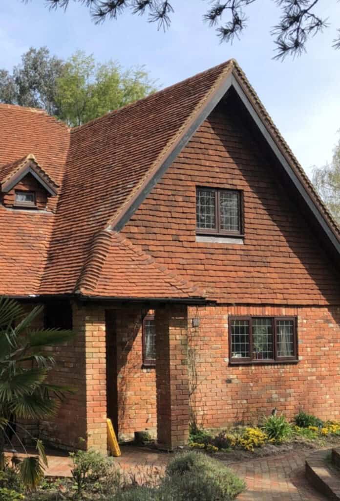 Tudor clay roof tiles used on both the roof and the walls. Giving the how building a warm lived in look