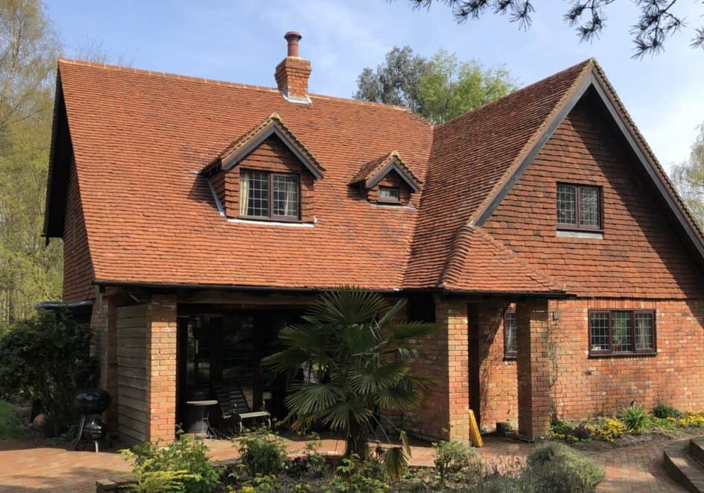 Tudor House using clay tiles on the roof and walls