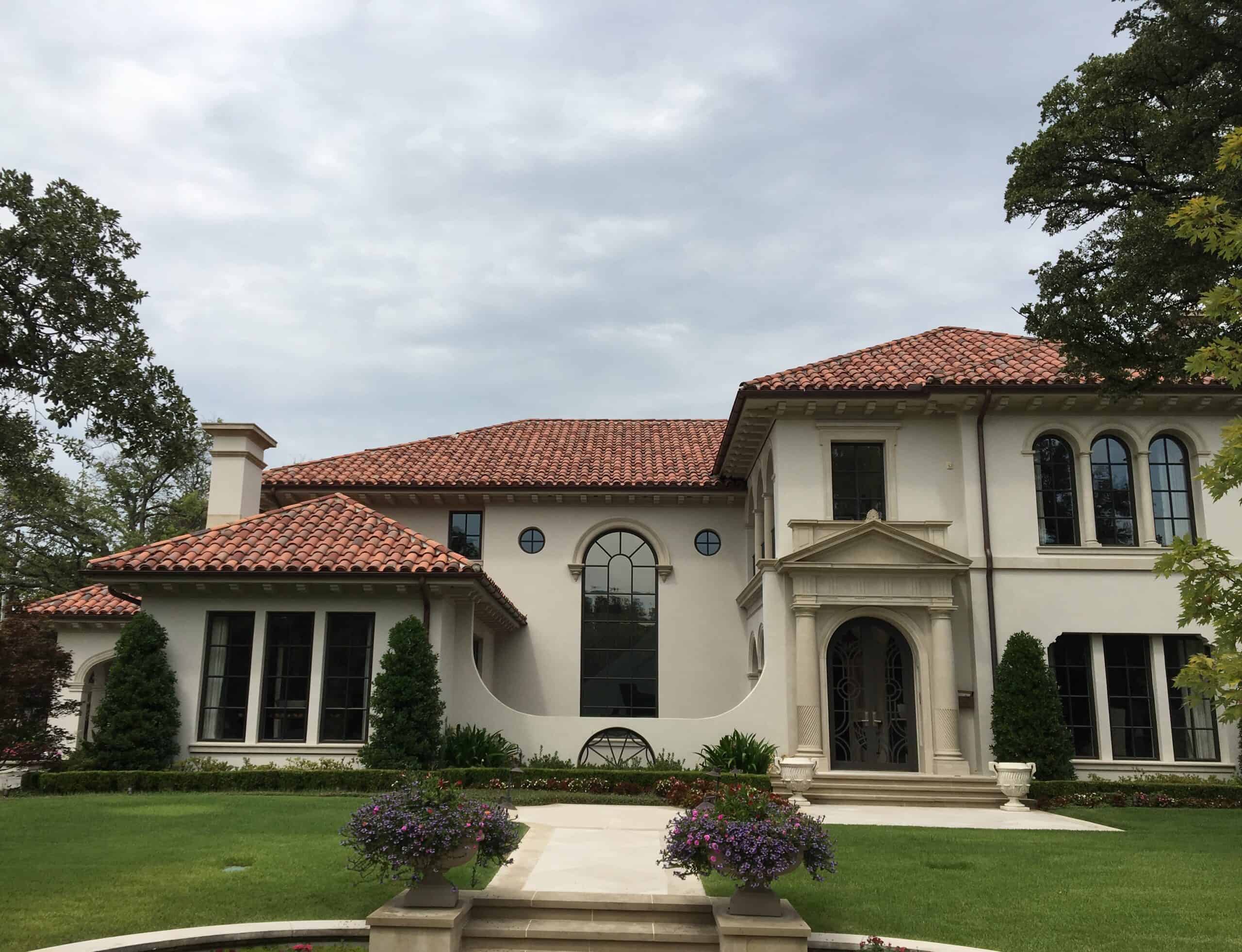 Soft flashes of charcoal and sienna give this classic roof a unique personality without overpowering the design. - Castilla Clay Tile Sunset Blend